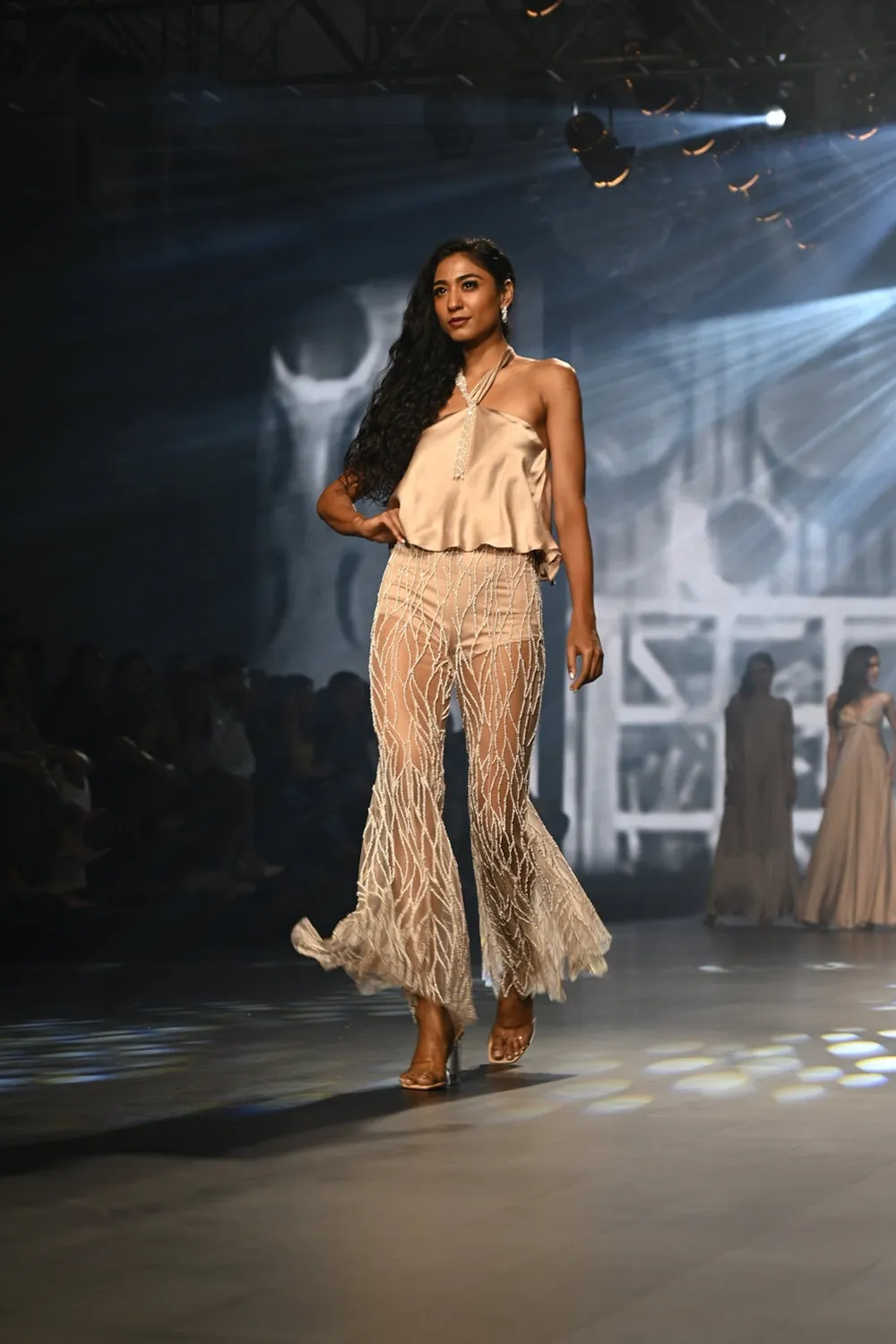 Taupe halter top with intricately embroidered flared pants.