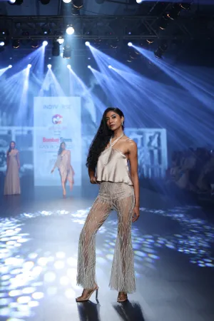 Taupe halter top with intricately embroidered flared pants.